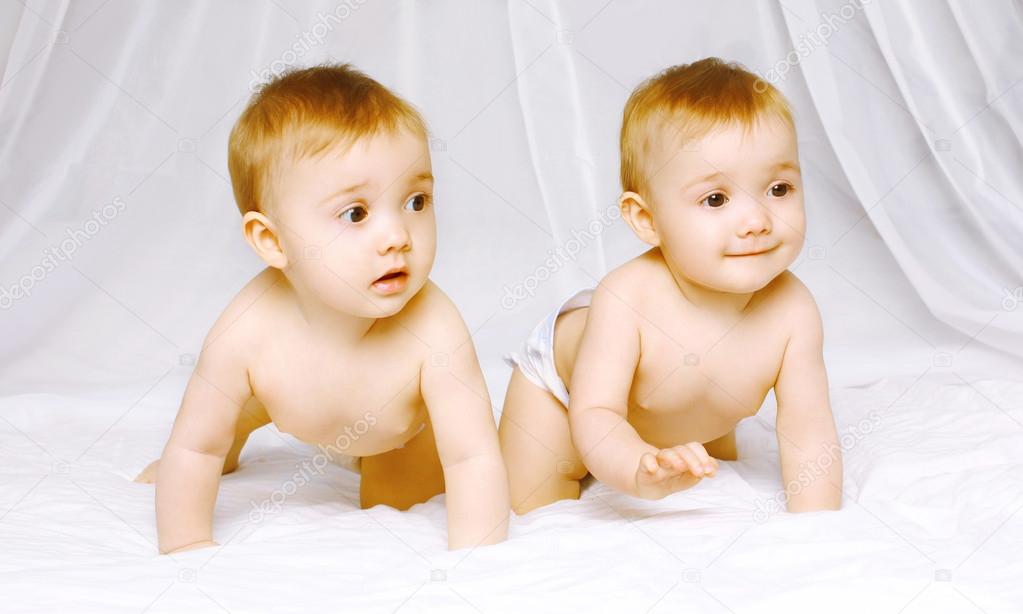 Cute twins baby on the bed