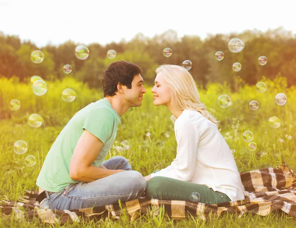 Pretty romantic couple in love having fun soap bubbles — Stock Photo, Image