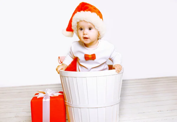 Christmas and people concept - playful baby with gifts — Stock Photo, Image