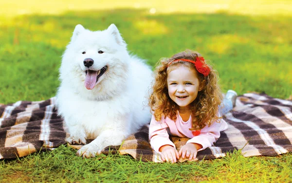 Happy positive little girl and dog having fun in sunny autumn da — Stock Photo, Image