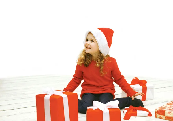 Christmas and people concept - joyful little girl in santa hat w — Stock Photo, Image