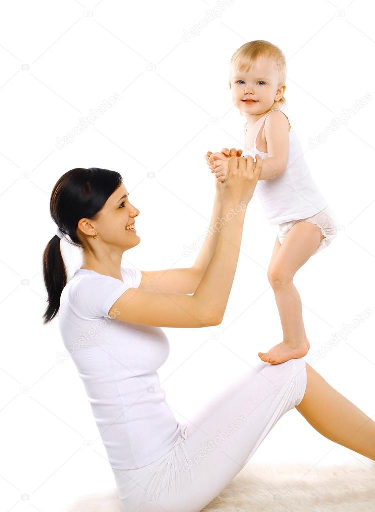 Sport, active, leisure and family concept - happy mom and baby d