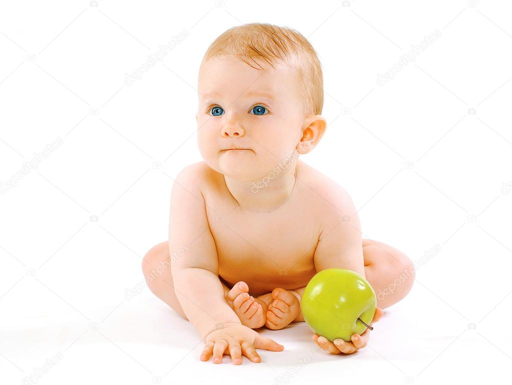 Food, health and child concept. Cute baby with green apple on a 