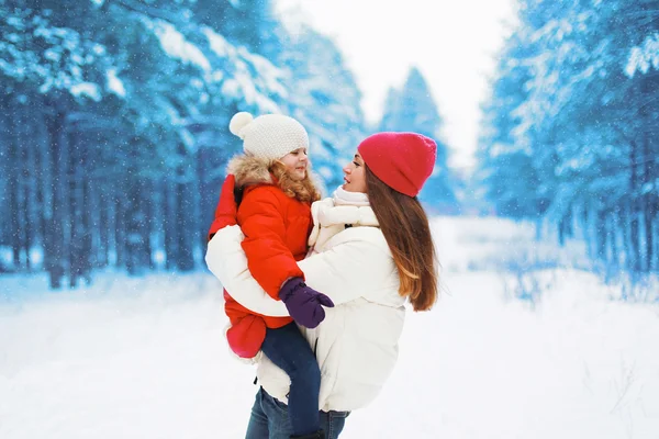 Happy young mother and child having fun outdoors in winter snowy — Stock Photo, Image