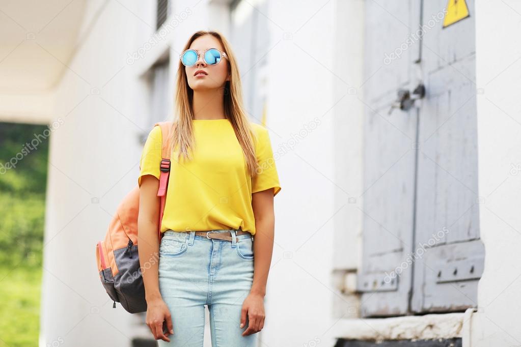 Street fashion concept - bright hipster girl in sunglasses outdo