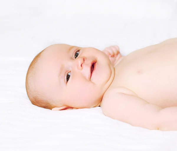 Portrait happy little baby on the bed — Stock Photo, Image