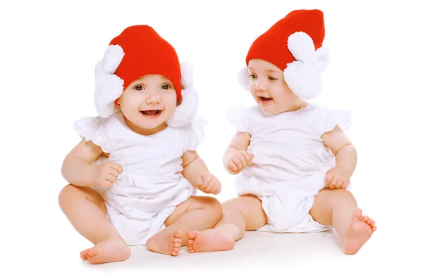 Twins baby playing in hats — Stock Photo, Image