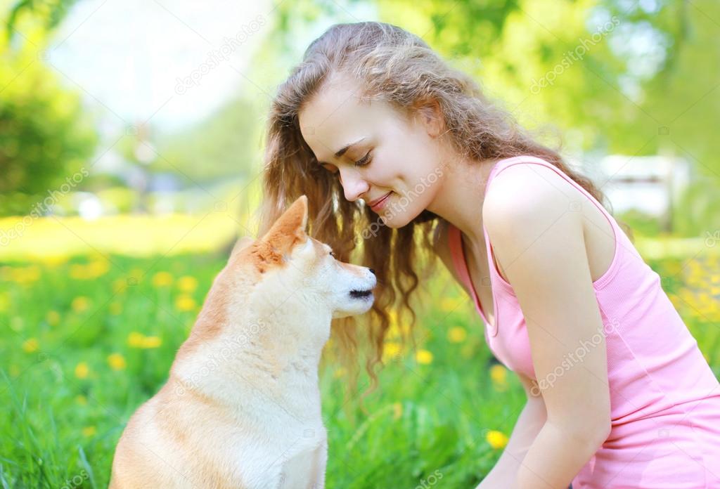 Happy girl and dog in sunny day
