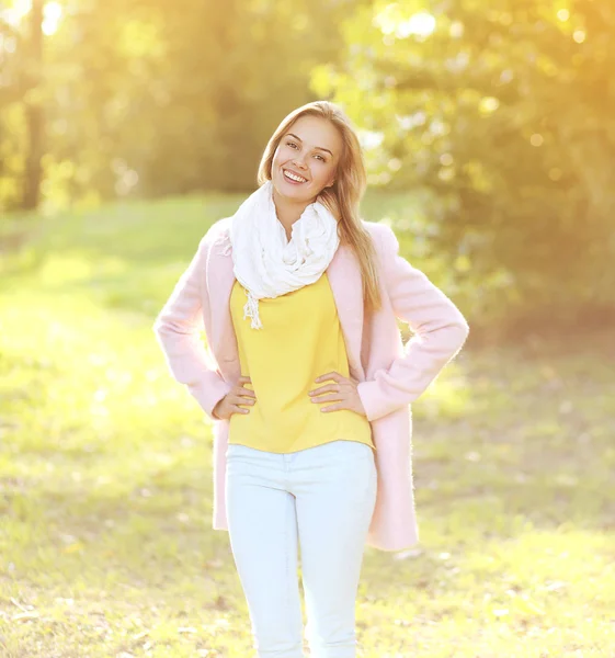 Pretty smiling woman in coat outdoors sunny autumn day — Stock Photo, Image