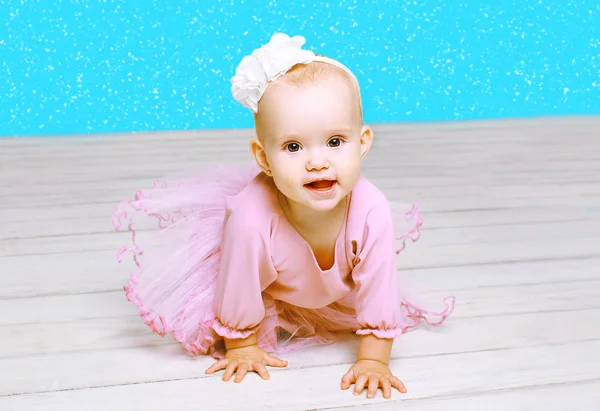 Christmas and people concept - cute little girl baby in pink dre