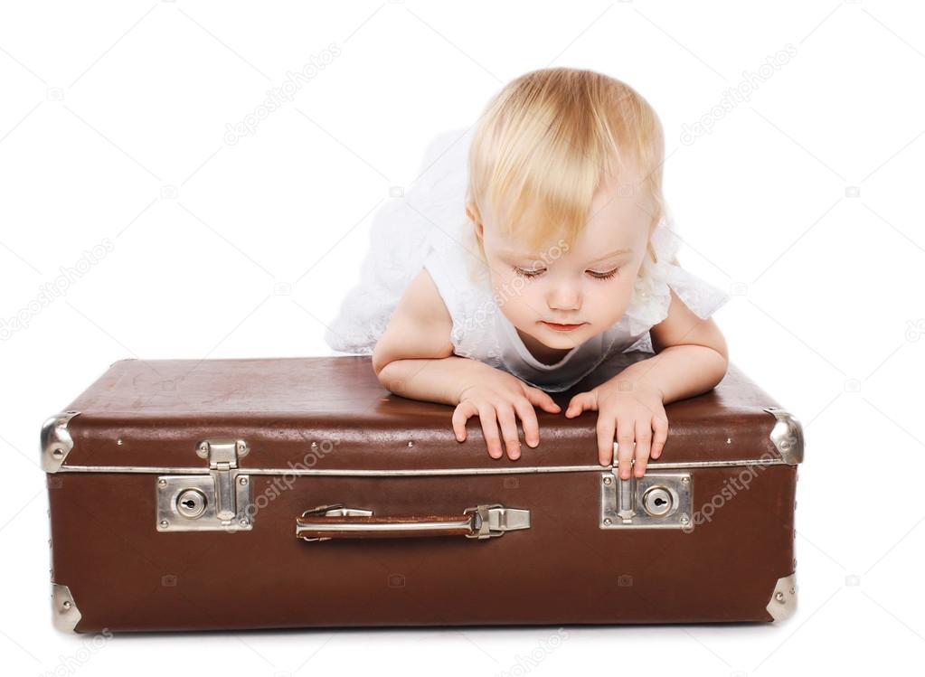 Little child and a suitcase, family travel - concept