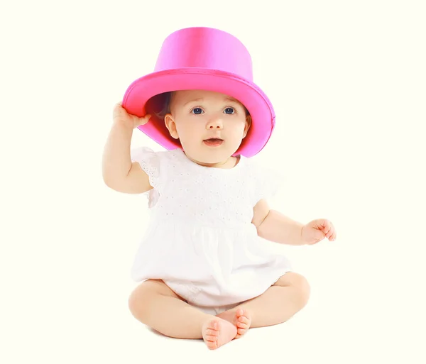 Portrait of sweet little baby sitting in pink hat — Stock Photo, Image