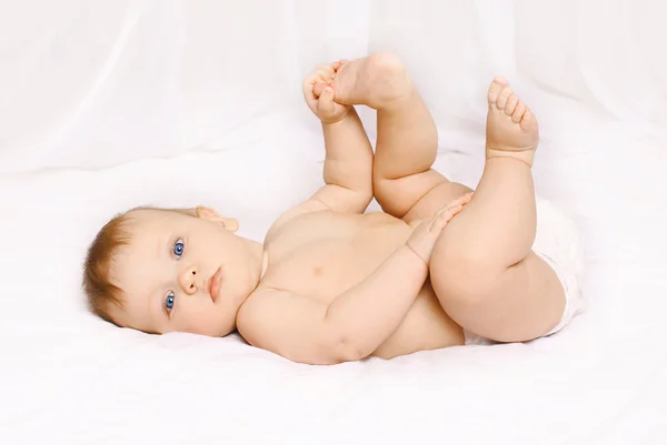 Bonito bebê doce deitado na cama em casa — Fotografia de Stock