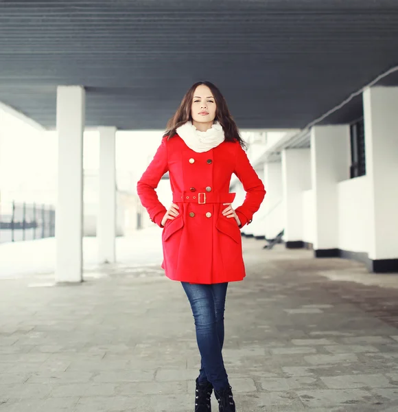 Pretty young woman in red jacket posing outdoors — Stock Photo, Image