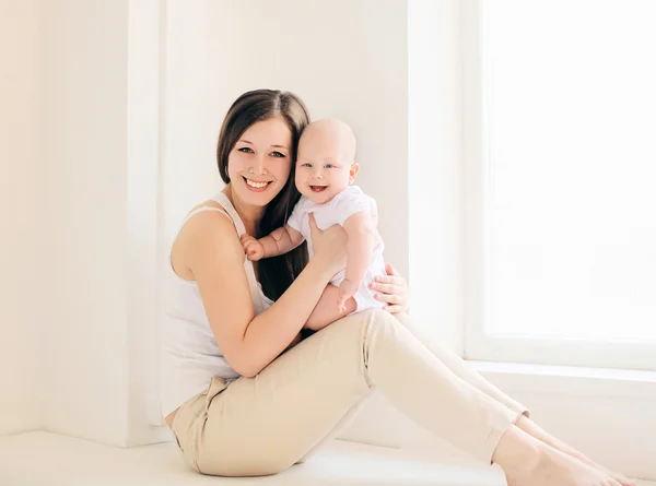 Happy mother and baby at home in light room — Stock Photo, Image