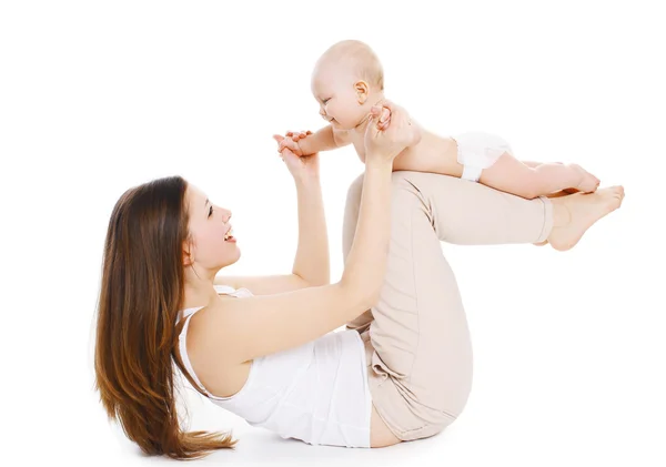 Mother and baby are doing exercise and having fun on a white bac — Stock Photo, Image