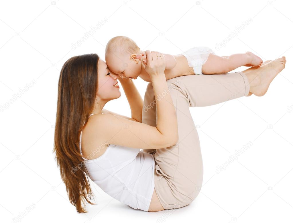 Young mother and baby are doing exercise and having fun on a whi