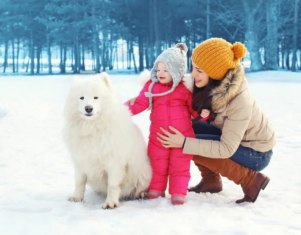 Bonne famille en journée d'hiver, mère et enfant marchant avec du blanc — Photo