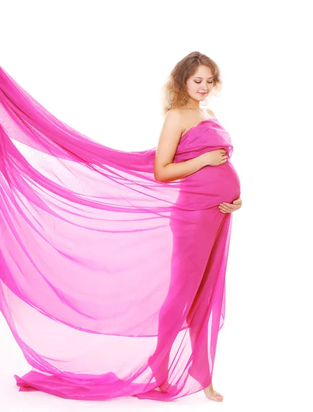 Beauté femme enceinte avec un tissu lumineux sur un fond blanc — Photo