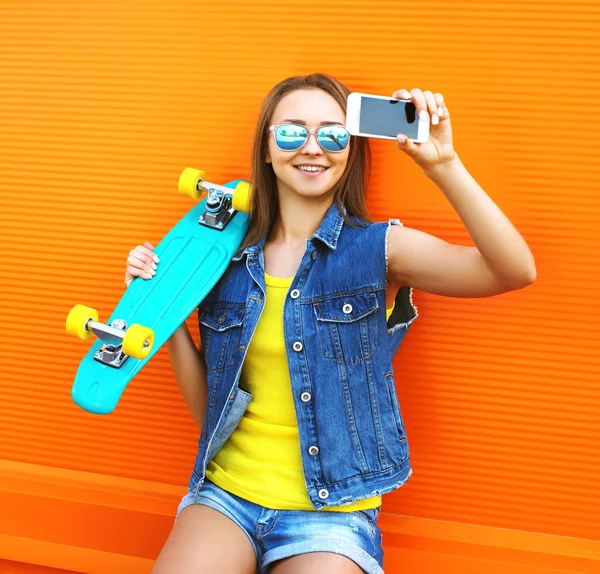 Fashion and technology concept - stylish young girl in colorful — Stock Photo, Image