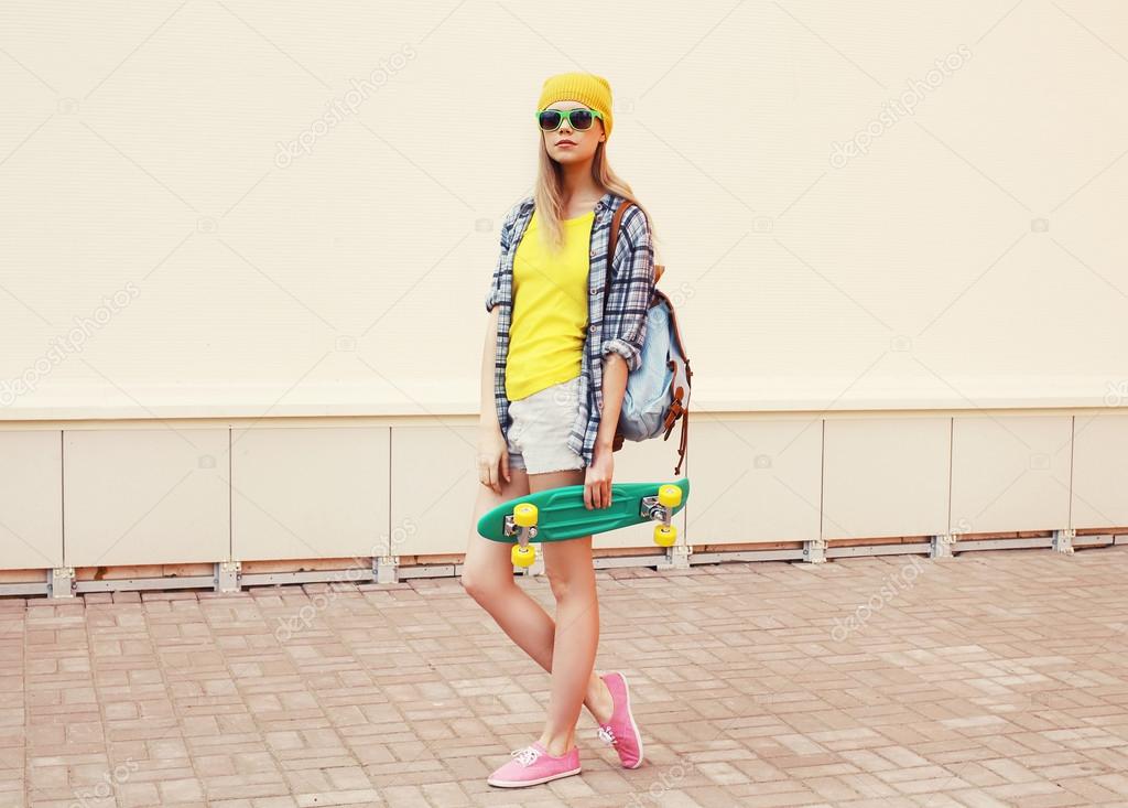 Fashion summer hipster cool woman in sunglasses and colorful clo