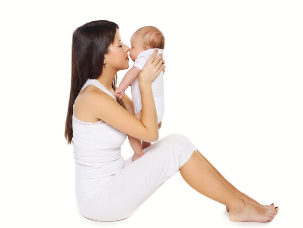 Portrait of happy young mother kissing cute baby 