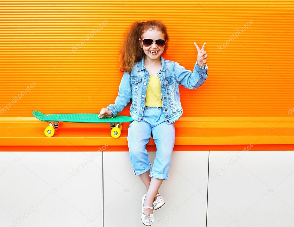 Fashion kid. Stylish little girl child wearing a jeans clothes a