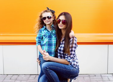 Fashion family concept - stylish mother and child wear a checker