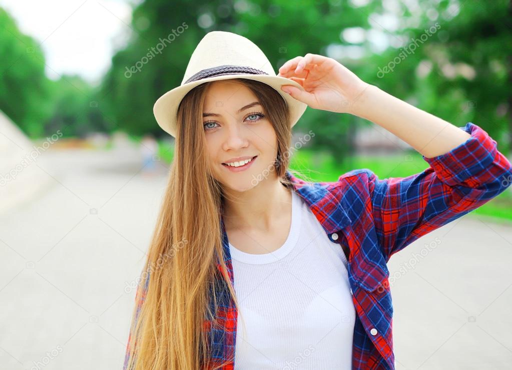 Portrait of beautiful smiling woman with long hair wearing a sum