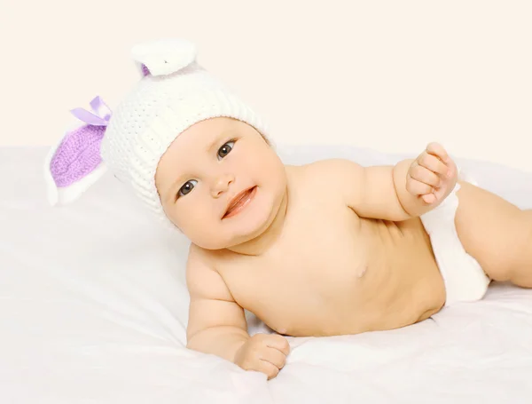 Retrato de bebê sorridente bonito em chapéu na cama em casa — Fotografia de Stock