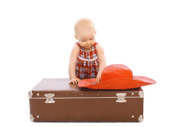 Child with straw summer hat and suitcase on a white background — Stok fotoğraf