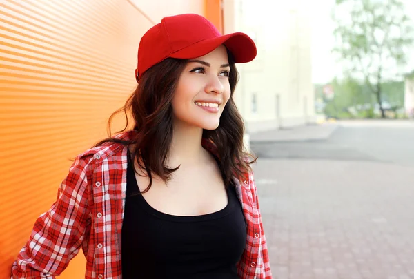 Portrait of pretty young smiling woman wearing a shirt and red c — ストック写真