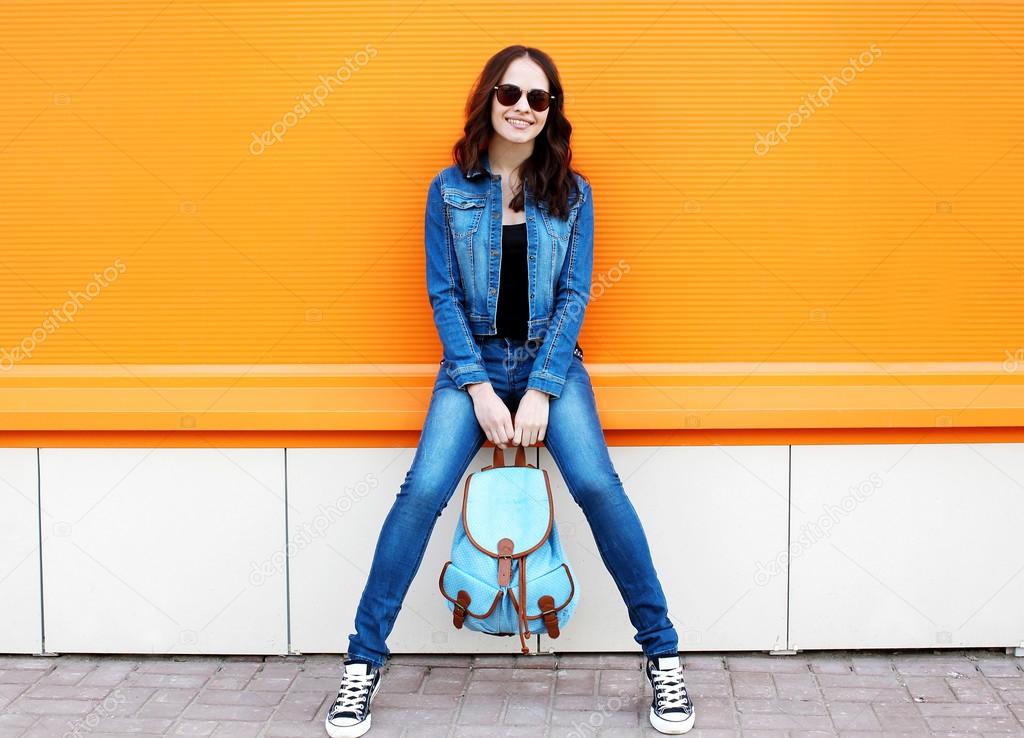 Stylish pretty young woman wearing a sunglasses and jeans clothe
