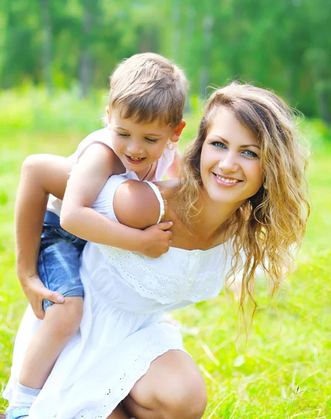 Happy mother with child son having fun outdoors in summer day Stock Photo