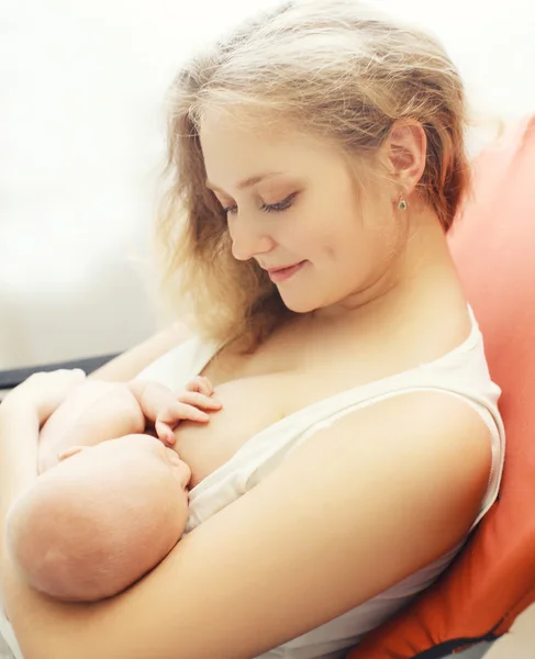 Portrait of happy young mom feeding breast baby at home — Stock Photo, Image