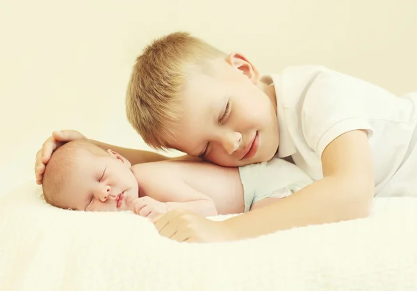 Two children lying sleeping on the bed at home, eldest brother h — Stock Photo, Image