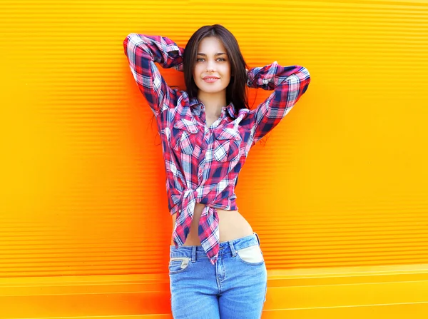 Portrait of pretty young slim woman wearing a checkered shirt an — Zdjęcie stockowe