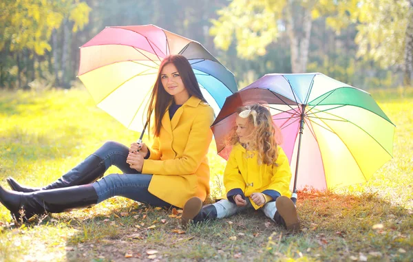 Hermosa madre y el niño con paraguas en el parque de otoño —  Fotos de Stock