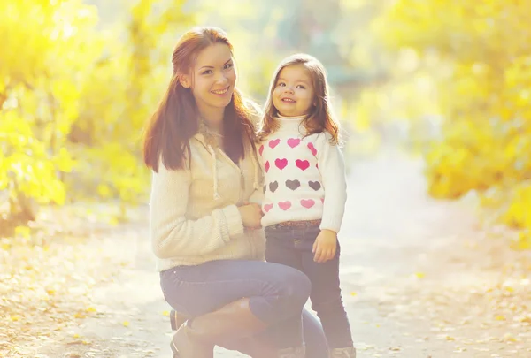 Mother and child walking in sunny autumn day — Stock Photo, Image