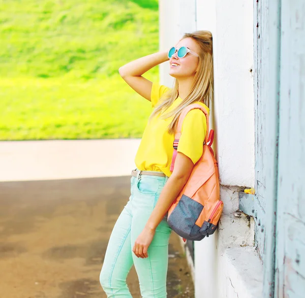 Mujer joven bonita y feliz con gafas de sol y camiseta amarilla — Foto de Stock