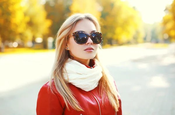 Portrait of fashion blonde woman wearing a sunglasses and red le