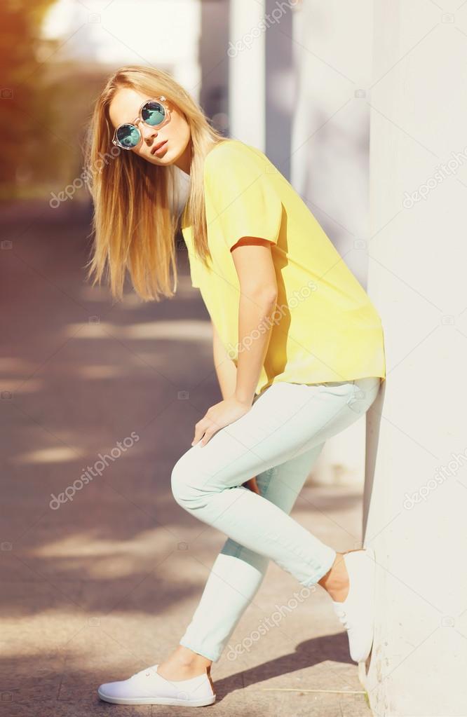 Fashion young woman in the city, stylish model posing outdoors