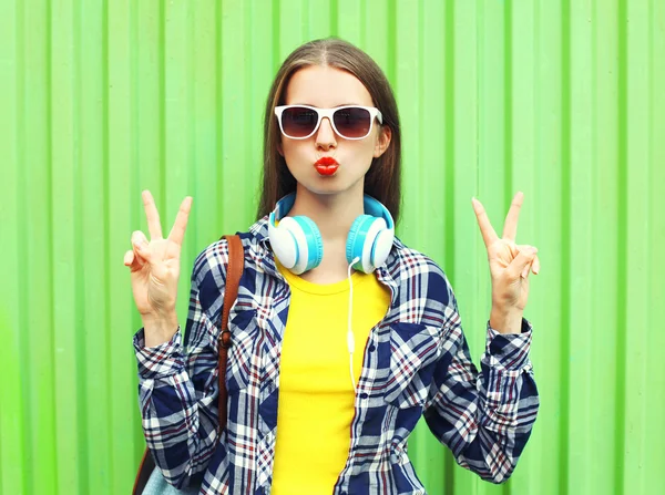 Moda menina muito legal vestindo um óculos de sol e fones de ouvido hav — Fotografia de Stock