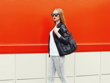 Fashion pretty woman wearing a rock black leather jacket, sungla