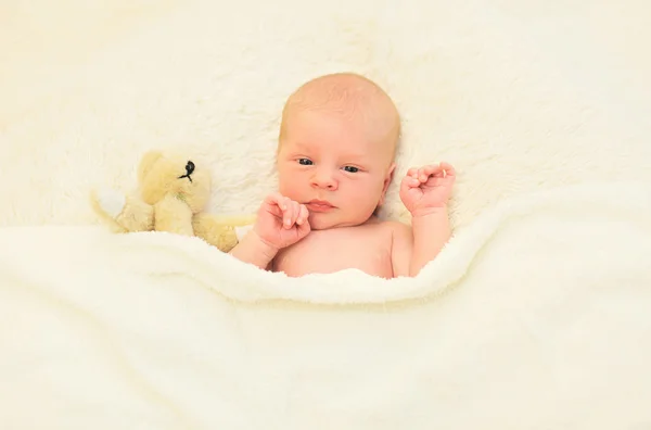 Cute baby sleeping together with teddy bear toy on the bed at ho — Stock Photo, Image