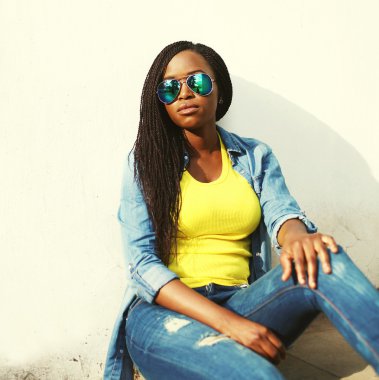 Beautiful african woman in colorful clothes and sunglasses