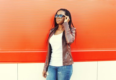 Beautiful african woman wearing a leather jacket and sunglasses