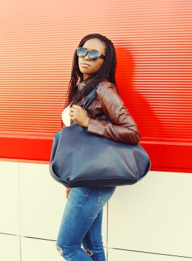 Portrait beautiful african woman wearing a leather jacket and su