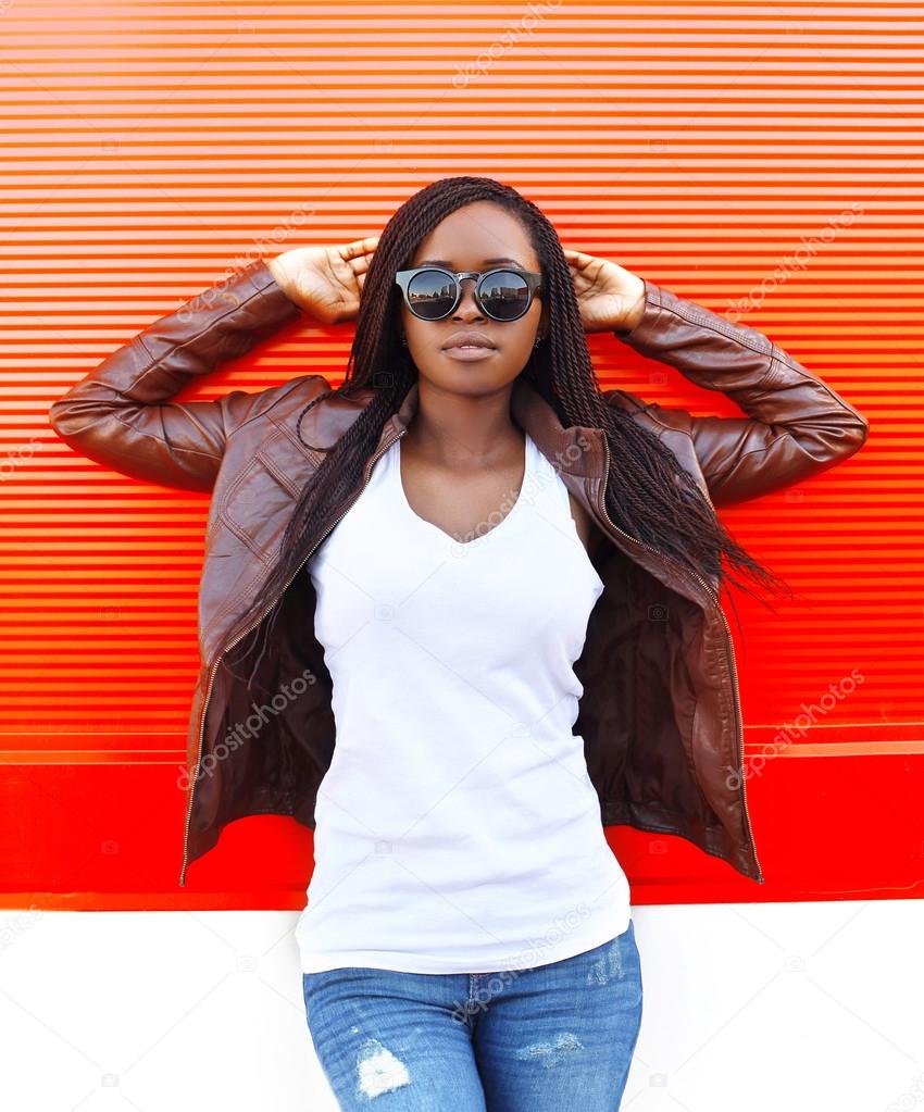 Portrait beautiful african woman wearing a leather jacket and su