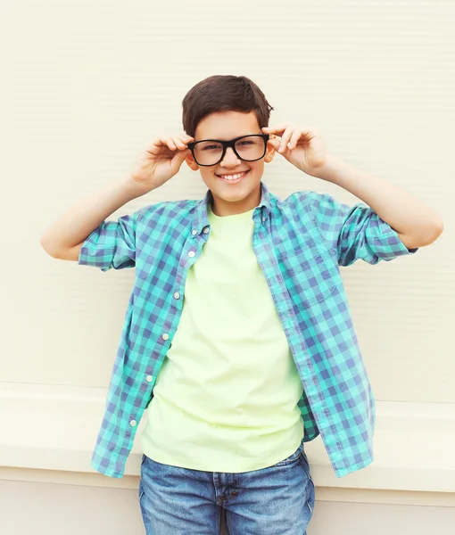 Happy smiling smart teenager boy in glasses wearing a checkered — Stock fotografie